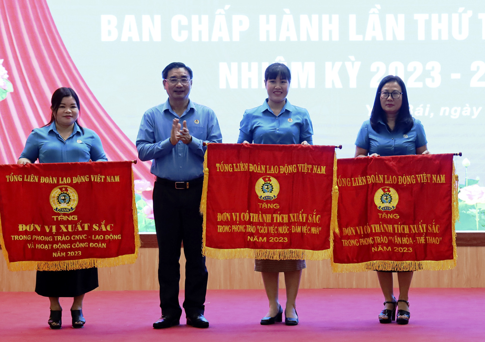 Được sự ủy quyền, đồng chí Nguyễn Chương Phát - chủ tịch LĐLĐ tỉnh trao cờ thi đua của Tổng LĐLD Việt Nam cho các tập thể